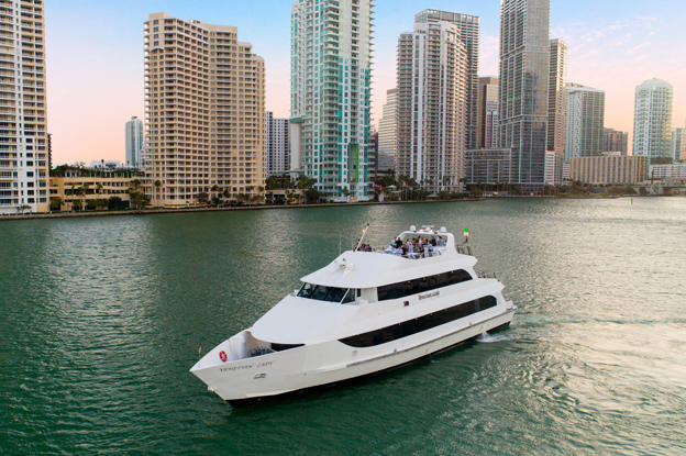 the biscayne lady yacht cruising down a river